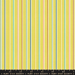 May include: Yellow fabric with vertical stripes in various colours, including blue, green, pink, and orange. The fabric is marked with a ruler and the text "RUBY STAR SOCIETY".