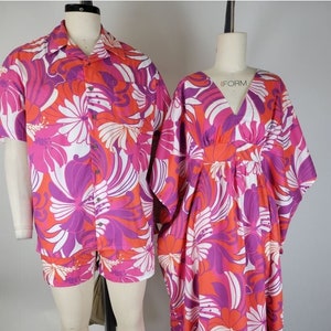 May include: A matching set of pink, orange, and white floral print clothing. The shirt has short sleeves and a button-up front. The pants are shorts. The dress has a V-neck and long sleeves.