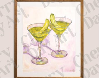 May include: A framed art print featuring two martini glasses with green liquid and a pickle garnish. The artwork has a light pink and white background, with a wooden frame.