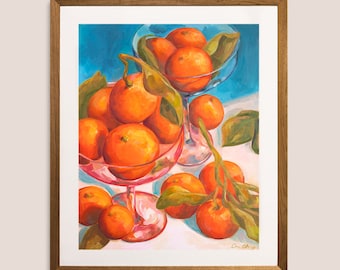 May include: A painting of a still life featuring a bowl of oranges. The bowl is pink glass and the oranges are arranged in a cluster. The oranges are a vibrant orange color and there are green leaves around the oranges. The background is a bright blue color.