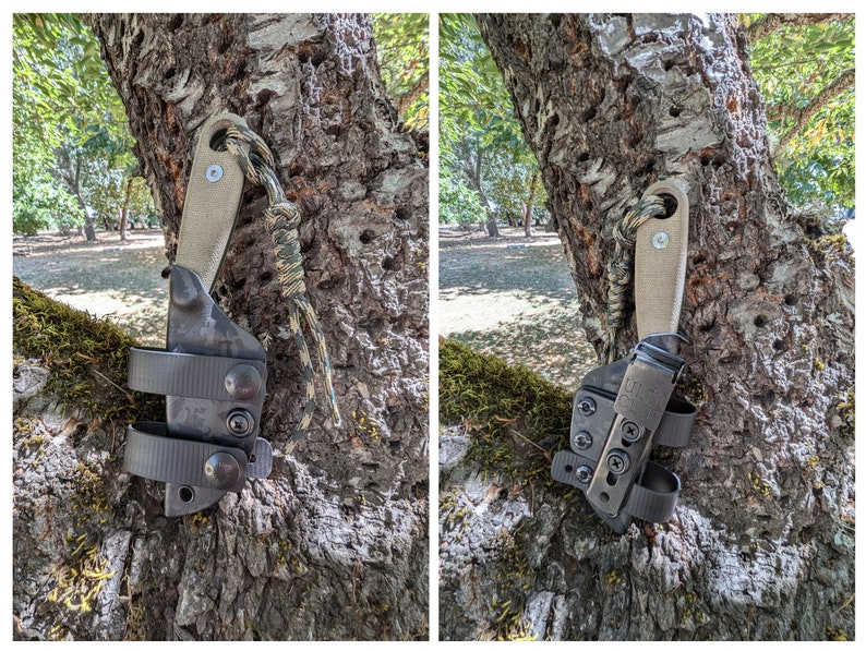 May include: A black leather knife sheath with a brown leather strap and a tan leather handle. The sheath is attached to a tree trunk with a green and brown camouflage paracord.