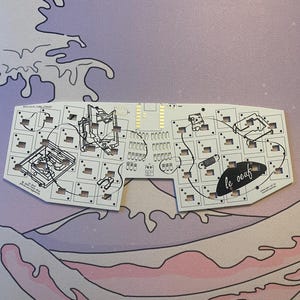 May include: A white keyboard plate with a black outline of a keyboard and the text "le oeaf" printed on it.