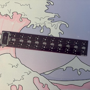 May include: A rectangular, dark purple printed circuit board with multiple holes and electronic components. The board is labeled with text and is set against a background featuring a wave design in pink, white, and purple.