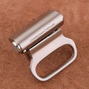May include: A silver metal belt buckle with the word "Picoulado" engraved on it.