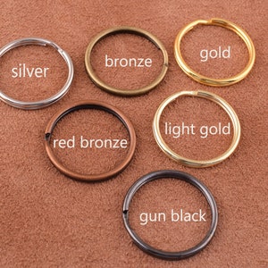 May include: Six different colored metal key rings. The key rings are silver, bronze, gold, light gold, red bronze, and gun black.