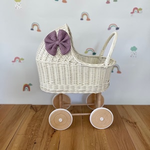 Wicker pram with bow, tall dolls pram, bow and bedding included. Cream/ off white