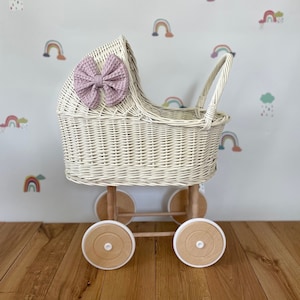 Wicker pram with bow, tall dolls pram, bow and bedding included. Cream/ off white