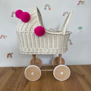 Wicker pram with bow, tall dolls pram, bow and bedding included. Cream/ off white pram with pink  pom-poms and bedding of your choice.