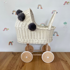 Wicker pram with bow, tall dolls pram, bow and bedding included. Cream/ off white pram with grey  pom-poms and bedding of your choice.