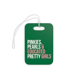 May include: Green luggage tag with white text that reads "Pinkies, Pearls & Educated Pretty Girls". The word "Educated" is in pink.