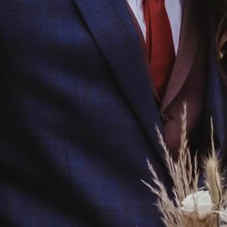 A photo of a burnt orange, cotton mens bow tie and a matching pocket square for wedding gifts