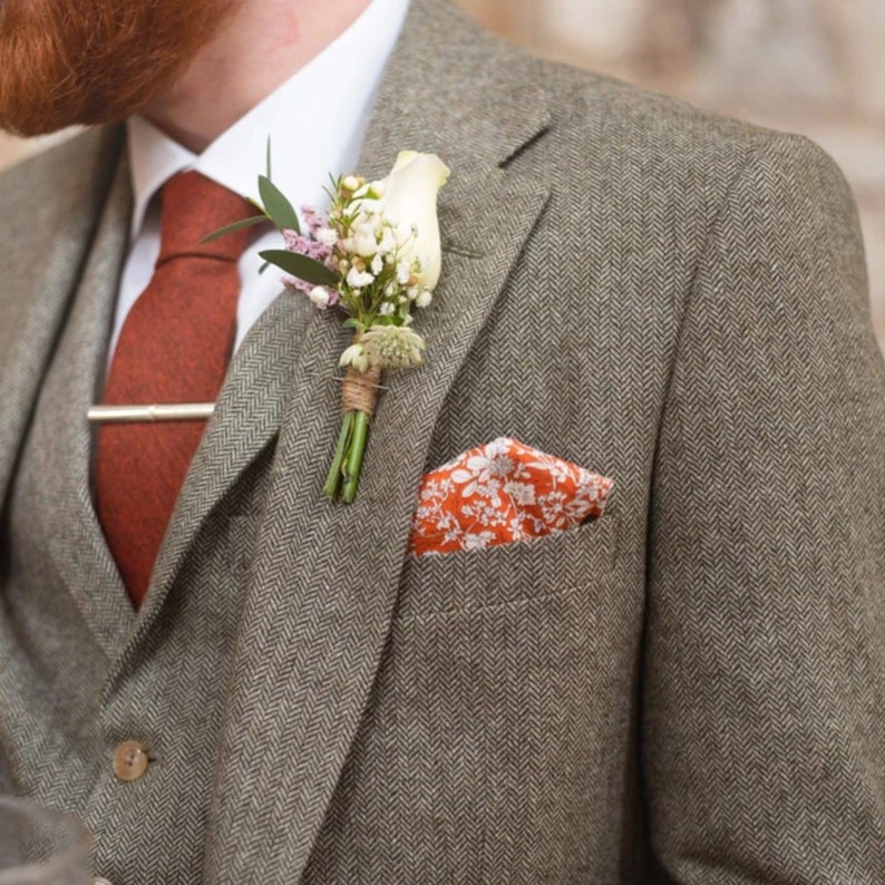 A burnt orange brushed cotton mens tie with an orange floral pocket square for weddings and as mens gifts