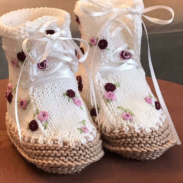 Hand-knitted baby boots for gentle up-and-coming rockers. In white with hand-embroidered roses.