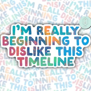 May include: A colorful sticker with the text "I'm really beginning to dislike this timeline" in a white circle with a speckled background.