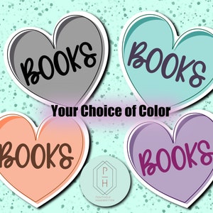 May include: Four heart-shaped stickers with the word "BOOKS" written in black cursive lettering. The hearts are in gray, teal, peach, and purple.