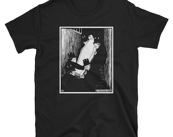 May include: Black t-shirt featuring a black and white illustration of two figures carrying a coffin. The artwork includes the text "LE MAINS PAS" at the bottom. The design is framed in a white border.