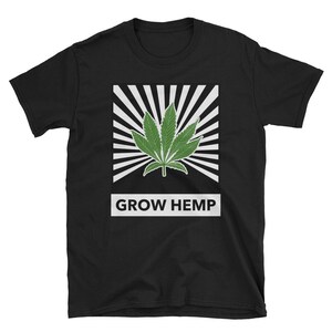 May include: Black t-shirt with a white graphic of a green hemp leaf with a sunburst design behind it. The text "GROW HEMP" is printed in white below the graphic.