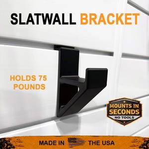 May include: Black slatwall bracket with the text "SLATWALL BRACKET". The bracket holds 75 pounds and mounts in seconds with no tools. The text "MADE IN THE USA" is also visible.