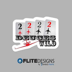 May include: A sticker with four playing cards showing the number two with a small airplane symbol on each card. The text "Deuces Wild" is written in black with a red airplane flying over the text. The sticker is white with a black outline.