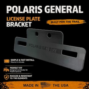 May include: Black Polaris General license plate bracket. The bracket is made of metal and has the words "Polaris General" embossed on it. The text "Built for the Trail" is also visible.