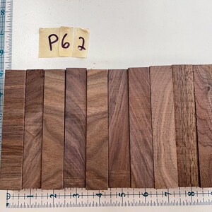 May include: A set of 10 wooden dowels, each approximately 4 inches long, arranged in a row. The dowels are a light brown color with a natural wood grain. The dowels are labeled "P62".