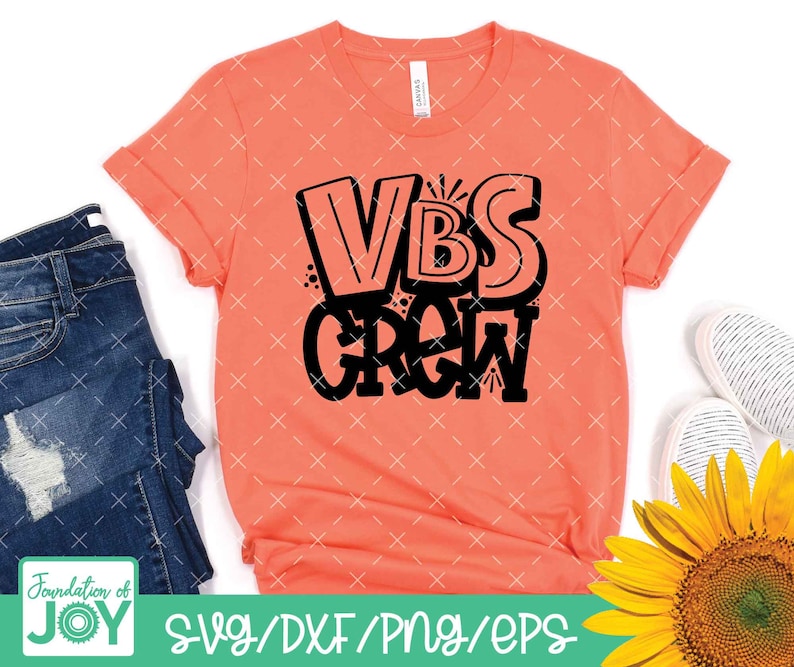 May include: A coral pink t-shirt with the text "VBS GROW" in black lettering. The text is in a stylised, bubble-like font.