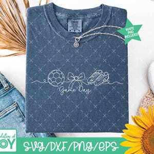 May include: A blue t-shirt featuring a white outline design of a football, bow, and football boots, with the text "Game Day". The shirt has a Comfort Colors label and a silver necklace. A green star with "White PNG Included" is also visible.