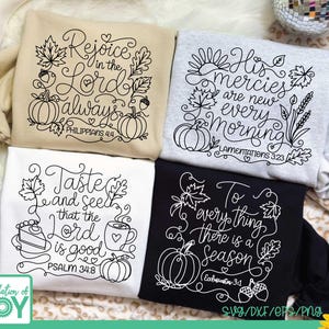 May include: Four sweatshirts in beige, light gray, white, and black, each featuring black or white line art designs with autumn-themed motifs like pumpkins, leaves, and acorns, alongside religious text including Bible verses and seasonal phrases.