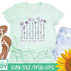 May include: A light green t-shirt with a design of flowers and the words "Fruit of the Spirit" with the scripture reference "Galatians 5:22".