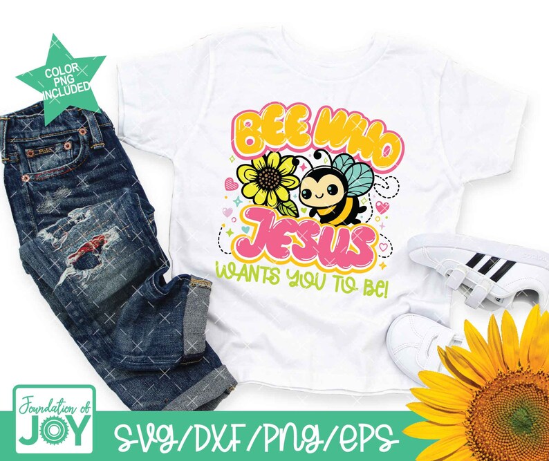 May include: A white t-shirt featuring a cartoon bee and the text "Bee Who Jesus Wants You To Be!" in colourful bubble letters. The bee has a yellow and black striped body with a cute face and wings. The design is surrounded by small hearts and stars.