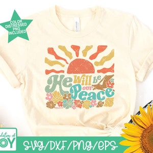 May include: A beige t-shirt with a retro-style graphic design featuring a sun, flowers, and the text "He will be our peace".