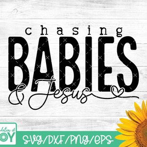 May include: Black and white graphic design with the text "chasing babies & Jesus" with a heart symbol. The design is on a white wood background.