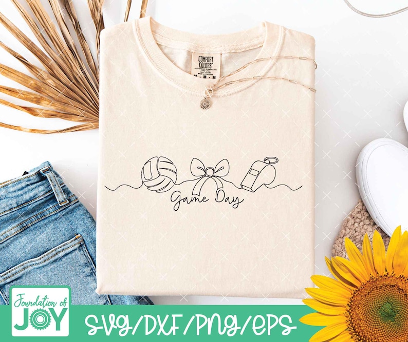 May include: Cream-colored t-shirt with a minimalist line art design featuring a volleyball, bow, and whistle, with the words "Game Day" in script. The shirt has a Comfort Colors tag and a delicate necklace. The bottom of the image has the text "Foundation of JOY" and "SVG/DXF/PNG/EPS".