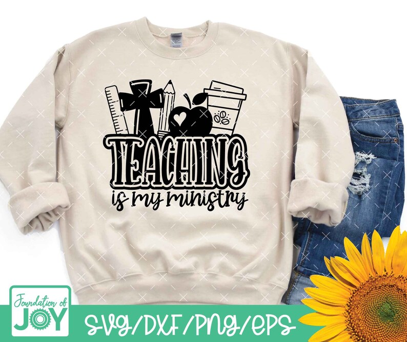 May include: A beige sweatshirt with a black graphic design that says "Teaching is my ministry". The graphic includes a red apple, a coffee cup, a ruler, a pencil, and a cross.
