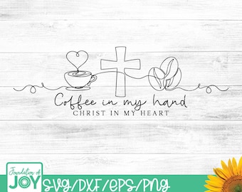 May include: A black and white line drawing on a white wooden background. The design includes a coffee cup with a heart, a cross, and coffee beans. The text reads "Coffee in my hand, Christ in my heart."