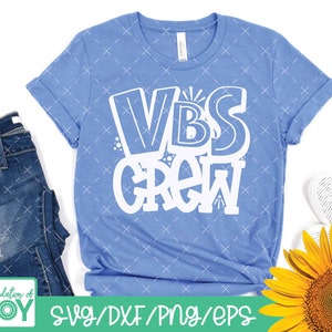 May include: A light blue t-shirt with the text "VBS Crew" in white. The text is in a playful, hand-drawn style.