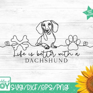 May include: A black line art design on a white background features a dachshund, a bone, and a paw print. The text "Life is better with a Dachshund" is below the dog. A sunflower is in the bottom right corner.