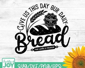 May include: Black and white graphic design with the text "Give us this day our daily bread" and "The Lord's Prayer". The graphic also includes a loaf of bread, wheat stalks, and a vintage-style label with the text "The Best Matthew 6:11 Premium Quality".