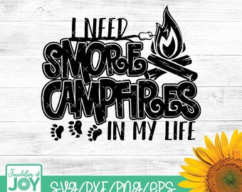 May include: Black and white graphic design with the text "I need s'more campfires in my life". The design includes a campfire with flames, a stick with a marshmallow on the end, and two footprints.