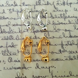 May include: Two pairs of earring clips. One pair is silver and the other pair is gold.