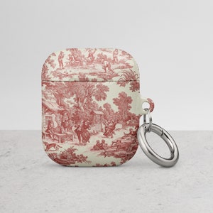 May include: A white and red patterned phone case with a silver metal ring attached. The pattern features a toile design with a red and white floral motif.
