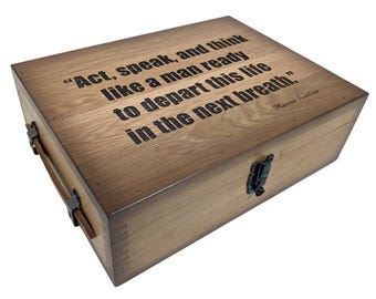 May include: A wooden box with a hinged lid and a metal latch. The box is engraved with the quote "Act, speak, and think like a man ready to depart this life in the next breath." by Mark Twain.