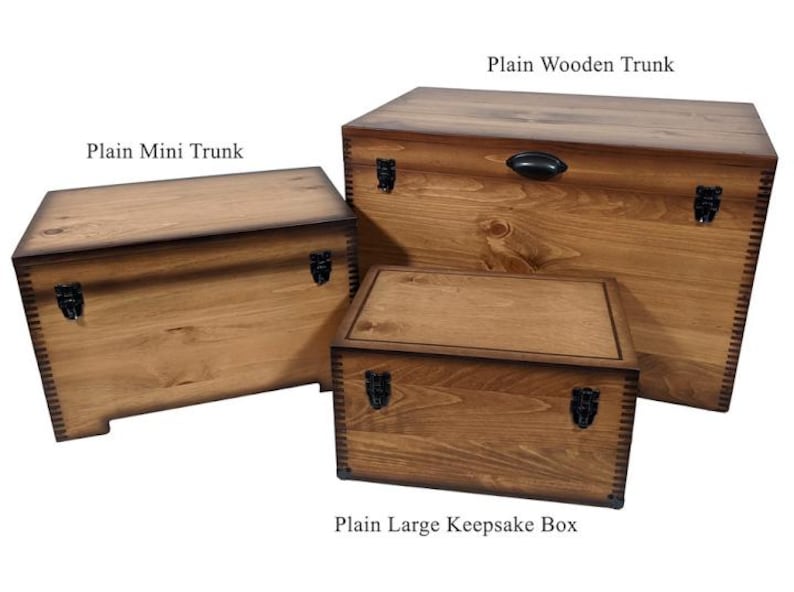 May include: Three wooden storage boxes with hinged lids and metal clasps. The smallest box is labeled "Plain Mini Trunk", the middle box is labeled "Plain Wooden Trunk", and the largest box is labeled "Plain Large Keepsake Box".