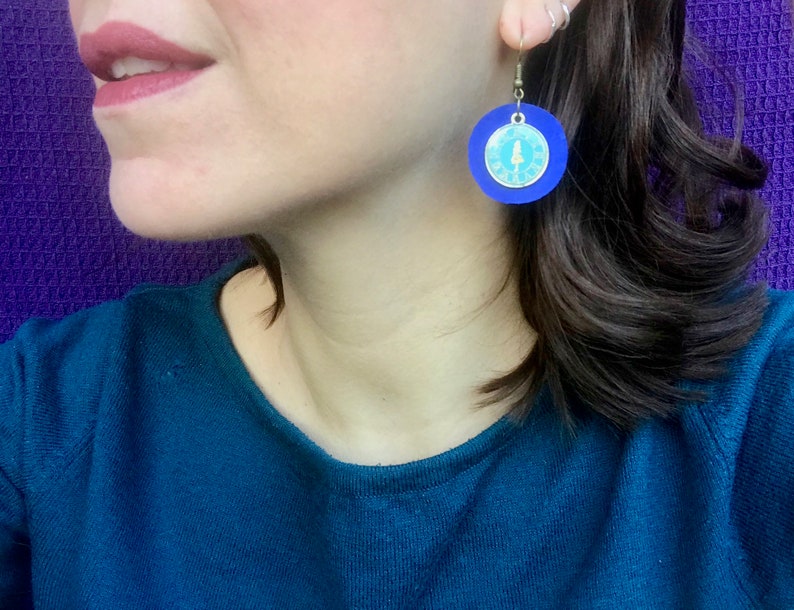 Round blue leather earrings with Alice in Wonderland charm; nickel free