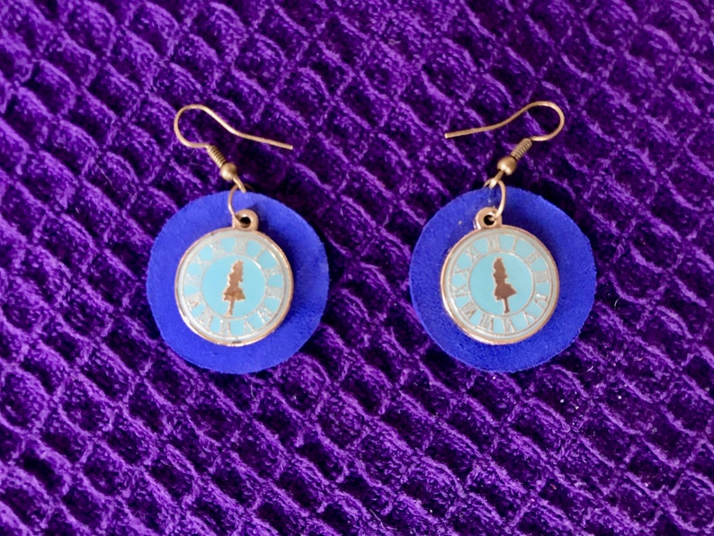 Round blue leather earrings with Alice in Wonderland charm; nickel free
