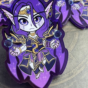 May include: A purple and gold anime character with long purple hair and a crown. The character is wearing a dark purple robe with gold accents and is holding a glowing orb in each hand. The background is a purple and white gradient.
