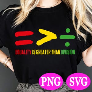 May include: A black t-shirt with a graphic design of red, yellow, and green symbols representing equality, greater than, and division. The text "Equality is greater than division" is printed below the symbols.