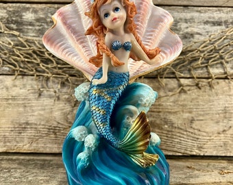 Beautiful Auburn Haired Mermaid with Shimmering Metallic Blue Tail Riding Cresting Ocean Wave Resin Statue