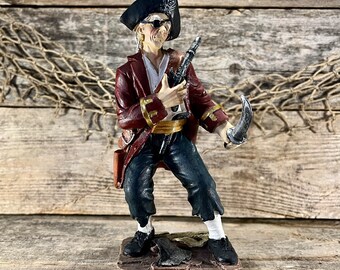 Hand-Painted Resin Pirate Captain Standing On Axe with Sword and Pistol Drawn Statuette