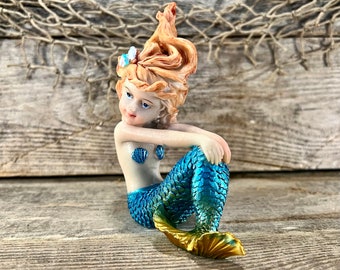 Miniature Right-Facing Resin Relaxing Mermaid with Red Flowing Hair and Metallic Blue and Gold Tail